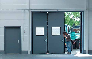 Industrial folding door with glazed sections